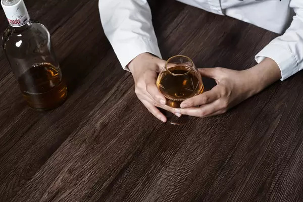 Tired of life problems person drinking whiskey