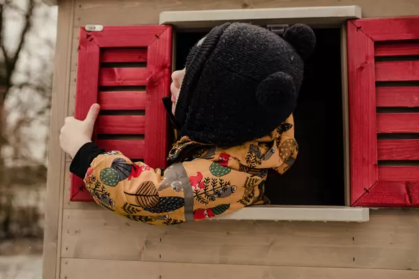 Toddler Playing In  Wooden House