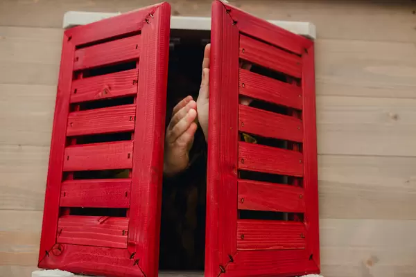 Toddler Playing With Red Window With Hands