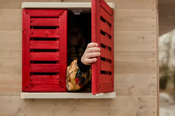 Toddler Playing With Red Windows