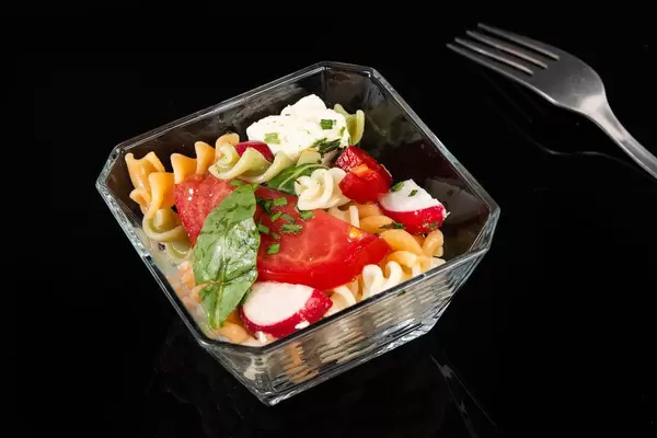 Tomato Radishes Rukola and Cheese salad above black background (Flip 2019)