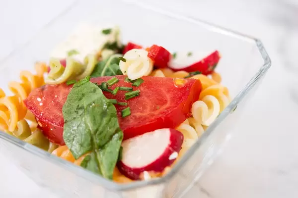 Tomato Radishes Rukola and Cheese salad in the glass bowl (Flip 2019)