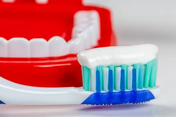 Toothbrush with toothpaste on the background of tooths model