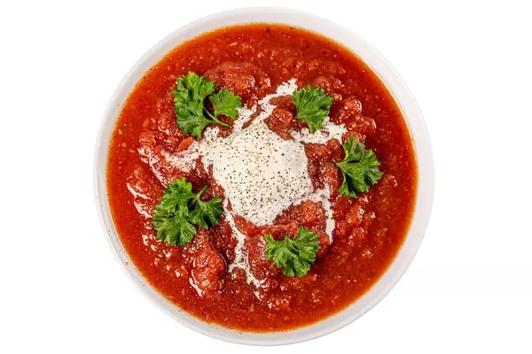 Top view, a bowl of tomato soup