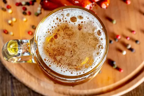 Top view a glass of beer on a wooden Board with spices