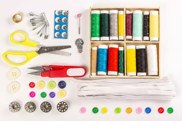 Top view, a set of threads, needles, buttons and other accessories for sewing