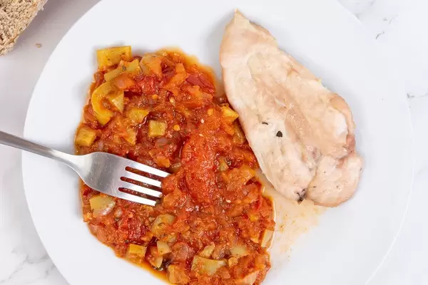 Top view above Tomato Stew with fried Chicken Breasts