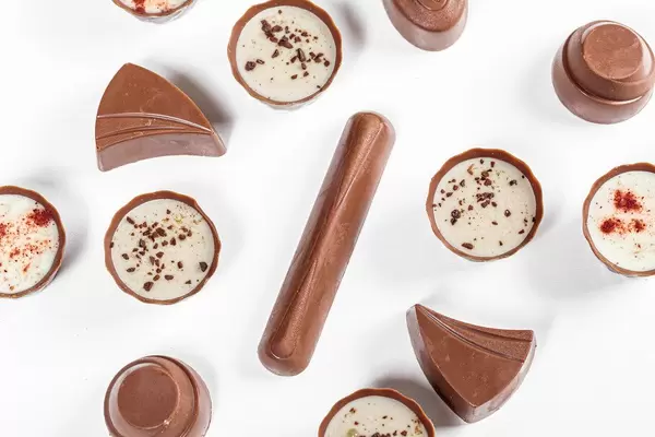 Top view assorted chocolates on a white background