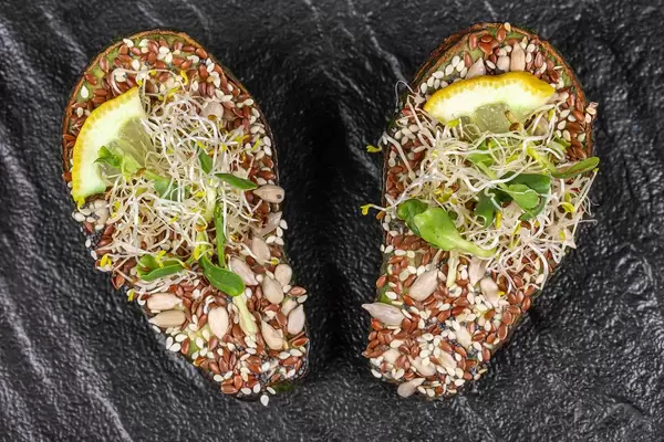 Top view, avocado with a mix of seeds and micro greens