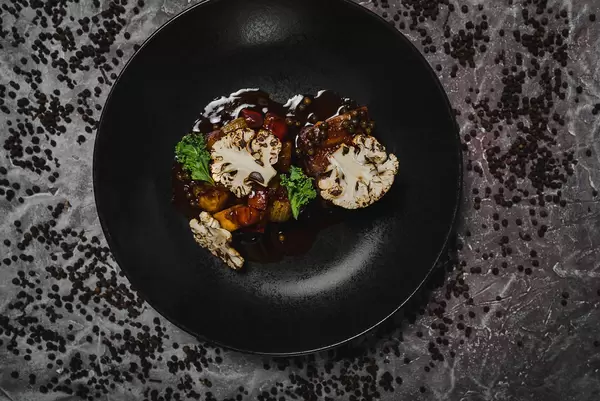 Top View BakedcauliflowrsWith Stake On Pepper Background