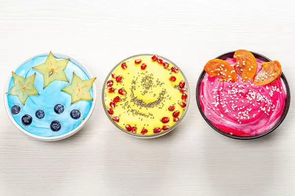 Top view beautiful and healthy Breakfast. Three different versions of oatmeal with fruit and seeds (Flip 2019)