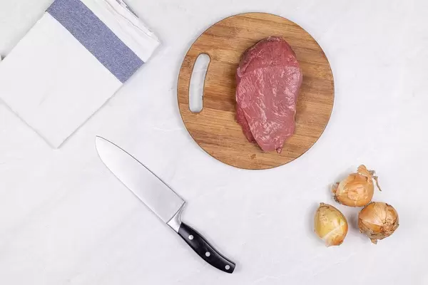Top view Beef Meat slice on the wooden board with Onions