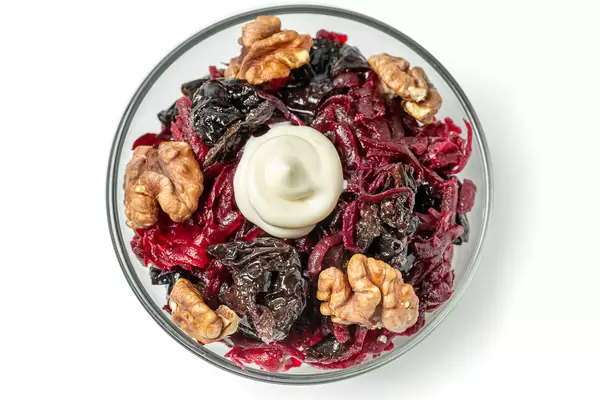 Top view, beetroot salad with walnuts and prunes