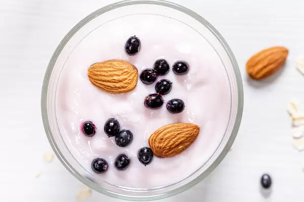 Top view black elderberry and almond nuts with yogurt on oatmeal (Flip 2019)