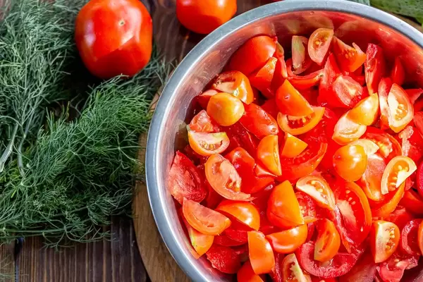 Top view, bowl with sliced fresh red tomatoes