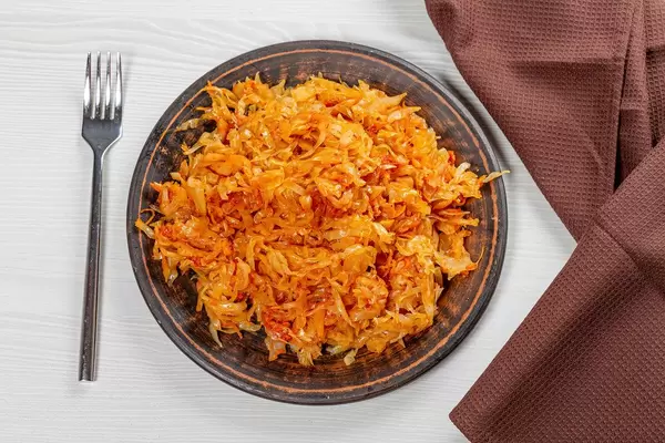 Top view braised cabbage on a plate on the table with a fork (Flip 2019)