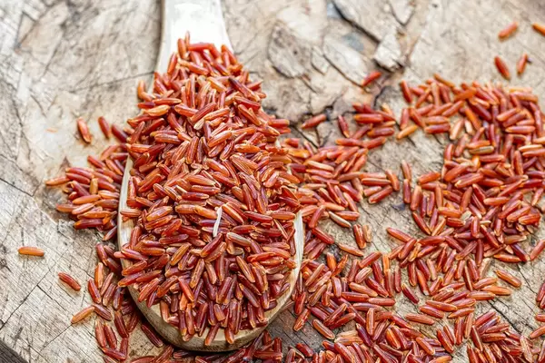 Top view brown rice in a wooden spoon