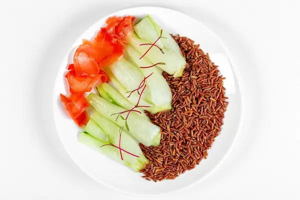 Top view, brown rice with pak choy baby cabbage and pickled ginger