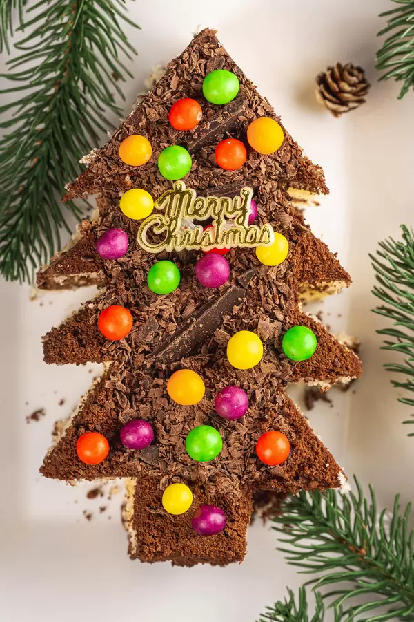 Top view, chocolate cake with colorful candies. Christmas dessert