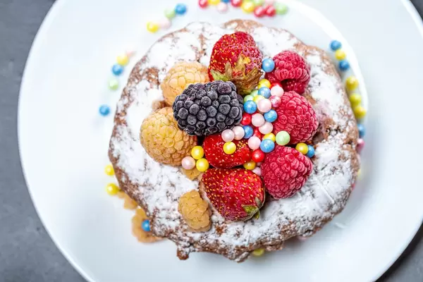 Top view chocolate cupcake with fresh berries and powdered sugar (Flip 2019)