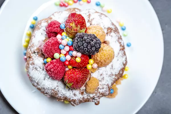 Top view chocolate cupcake with fresh berries and powdered sugar