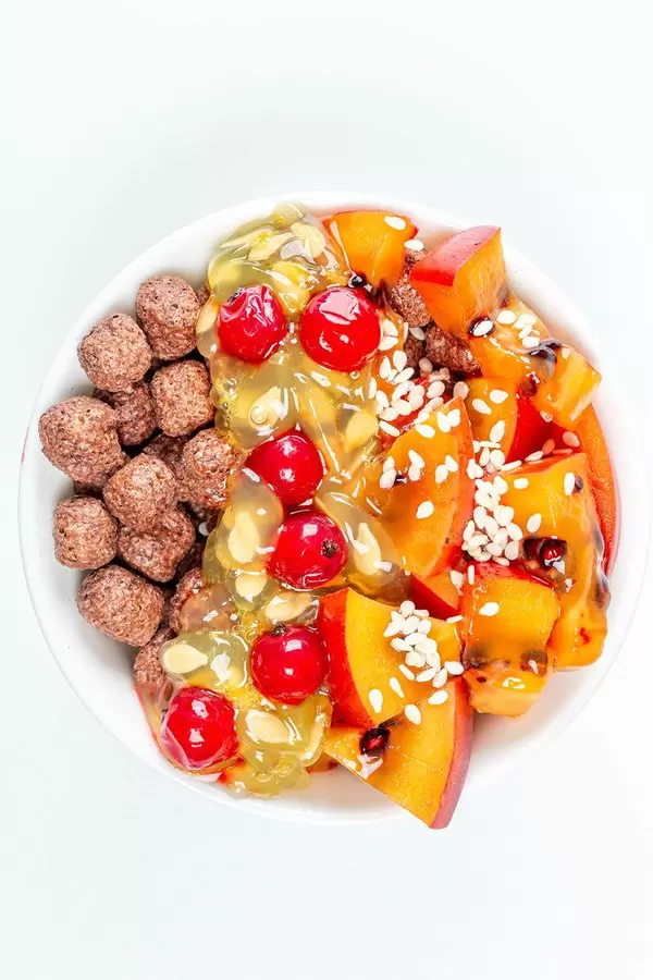 Top view, corn balls with slices of tamarillo, kiwano and red currant on a white background (Flip 2020)