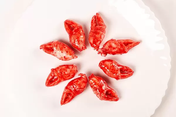 Top view, delicious cooked crab claws on white plate