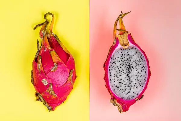 Top view, dragon fruit on pink and yellow background