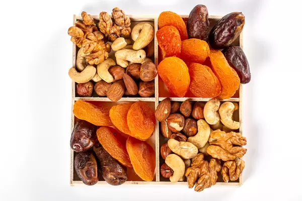 Top view, dried apricots, dates with various nuts in a box