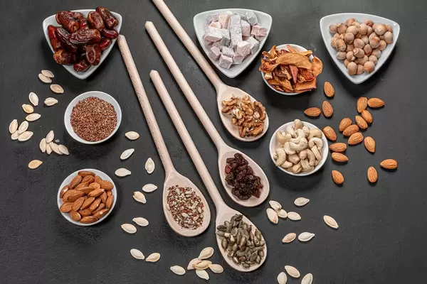 Top view dried fruits, nuts and seeds on a black background. Healthy food concept (Flip 2019)