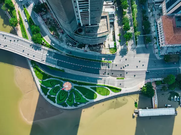 Top View Drone Photo of the historic Thu Ngu Flagpole at Saigon River with Traffic on Khanh Hoi Bridge in Ho Chi Minh City, Vietnam