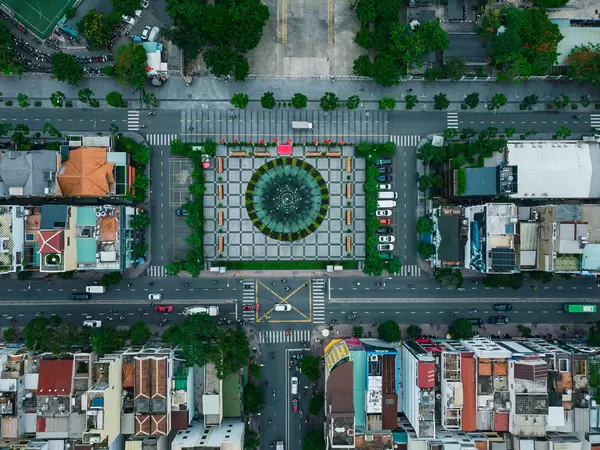 Top View Drone Photo of Traffic on the Streets around a Square with Water Fountain at the Kahnh Hoi Public Park in District 4 in Ho Chi Minh City, Vietnam