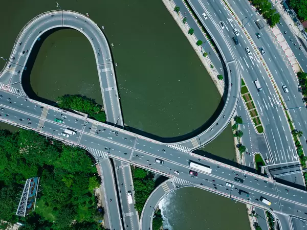 Top View Drone Photo of Traffic with Cars and Motorbikes on a Multi Level Bridge over Saigon River in Ho Chi Minh City, Vietnam