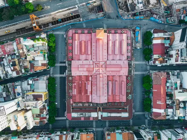 Top View Drone Shot of Tourist Attraction Ben Thanh Market next to the construction of Saigon Metro Central Station in Ho Chi Minh City, Vietnam