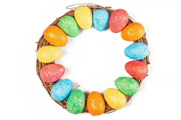 Top view, easter round wreath with colorful eggs