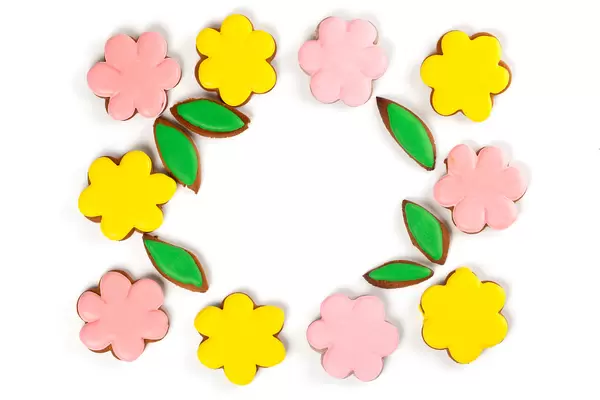 Top view, frame of yellow and pink gingerbread flowers