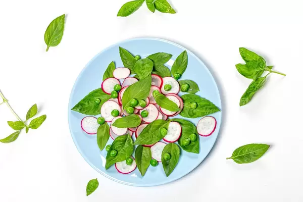 Top view fresh Basil leaves and radish slices on white background (Flip 2019)