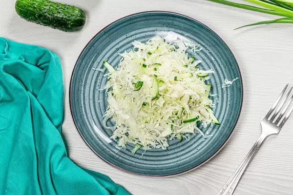Top view fresh coleslaw in plate on white wooden background with fork (Flip 2019)