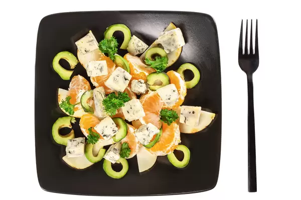 Top view, fresh salad with avocado, pear, dor blue cheese and tangerines