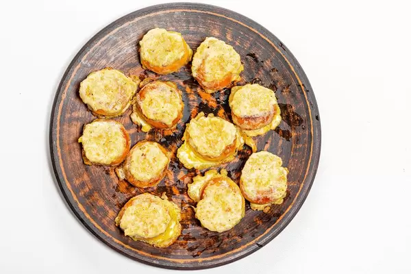 Top view fried bagels with meat filling in a plate on a white background