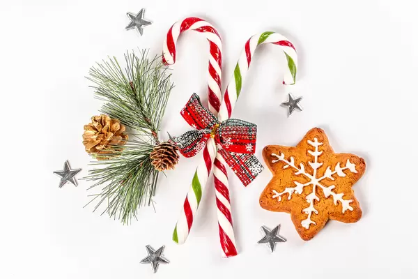 Top view, gingerbread snowflake with christmas decor and lollipops