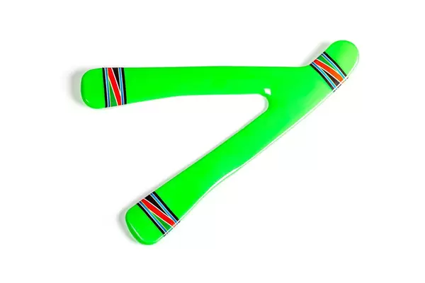 Top view, green plastic boomerang on white background