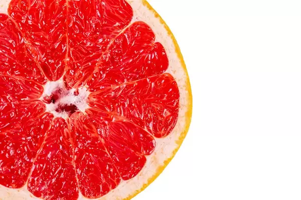Top view, half of a red grapefruit on a white background