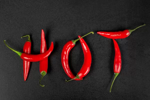 Top view hot made from red chili peppers on black