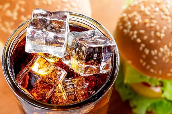 Top view ice cubes in a glass with a drink and burgers (Flip 2019)