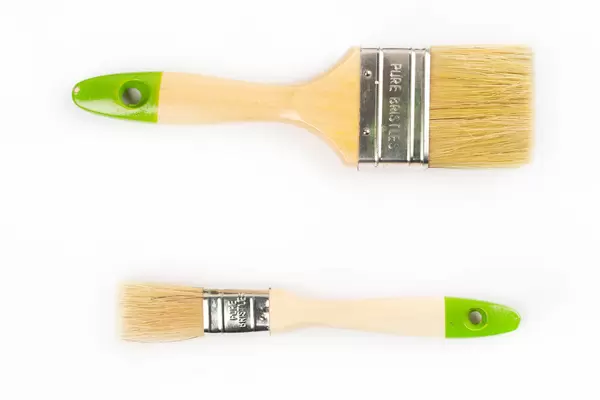 Top view, large and small wooden brushes on white