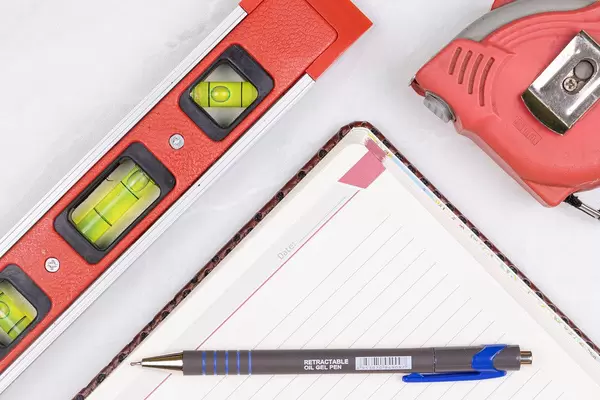 Top view Level Measure Tape Pencil and Paper Notebook
