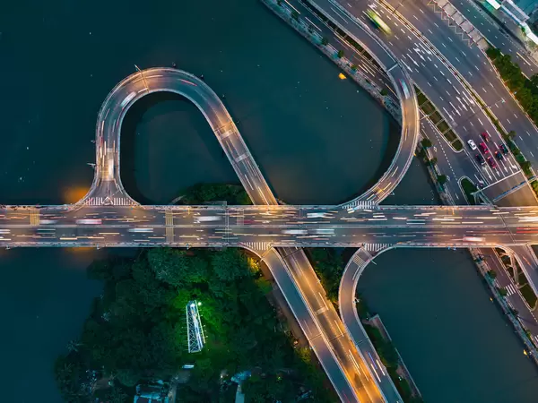 Top View Long Exposure Drone Photo of Traffic on a Bridge over Saigon River with colorful Lights in Ho Chi Minh City, Vietnam