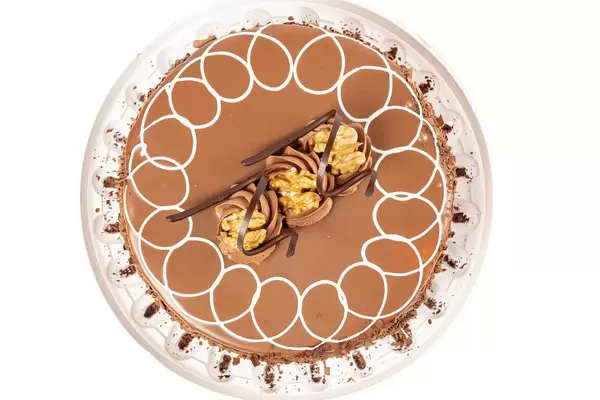 Top view, milk chocolate cake with meringues and walnuts