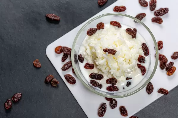 Top view milk rice porridge with raisins